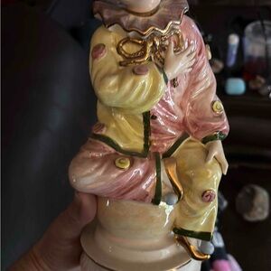 Vintage Capodimonte porcelain circus clown figurine music box with gold accents.